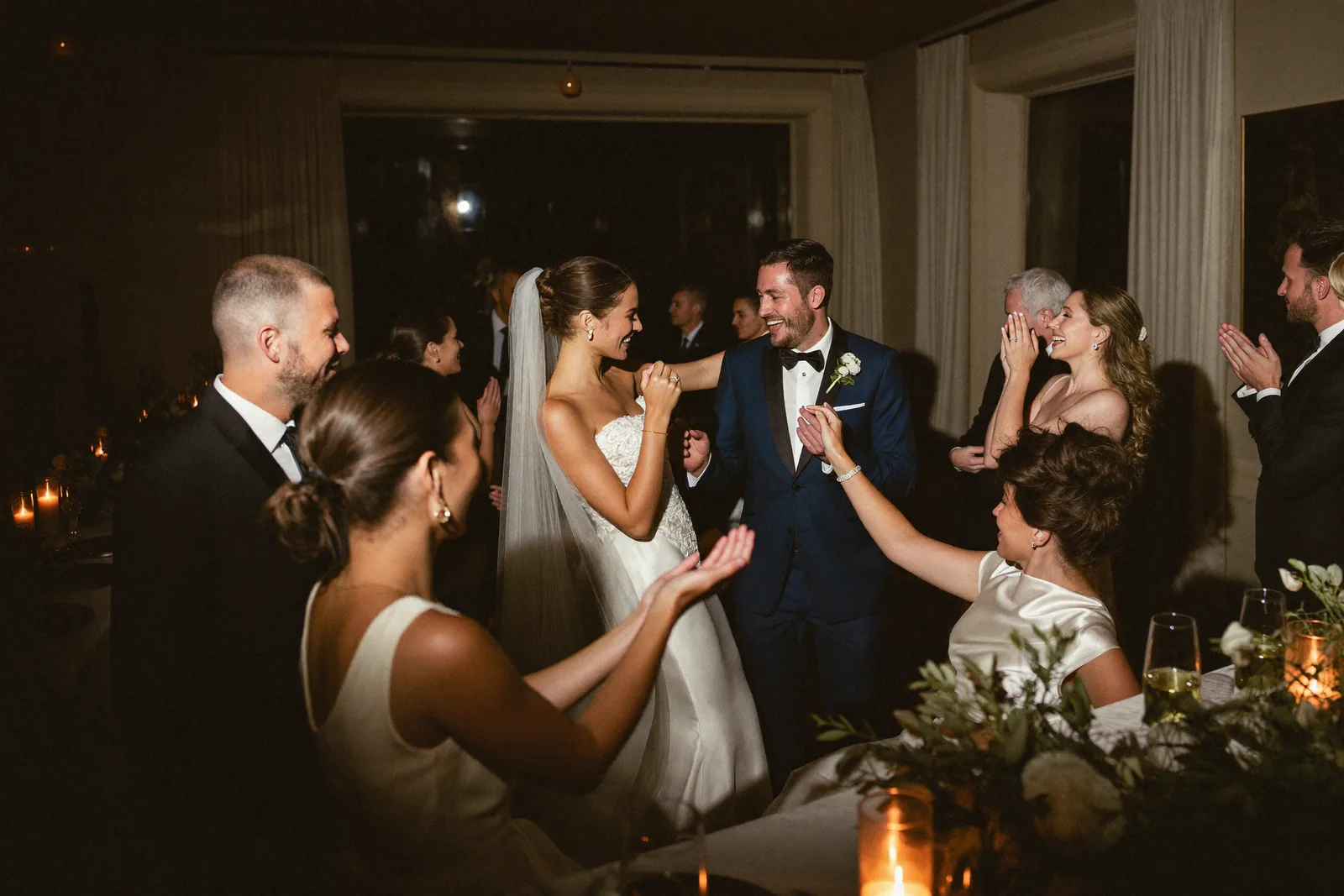 Bride and groom dancing with guests at a wedding reception