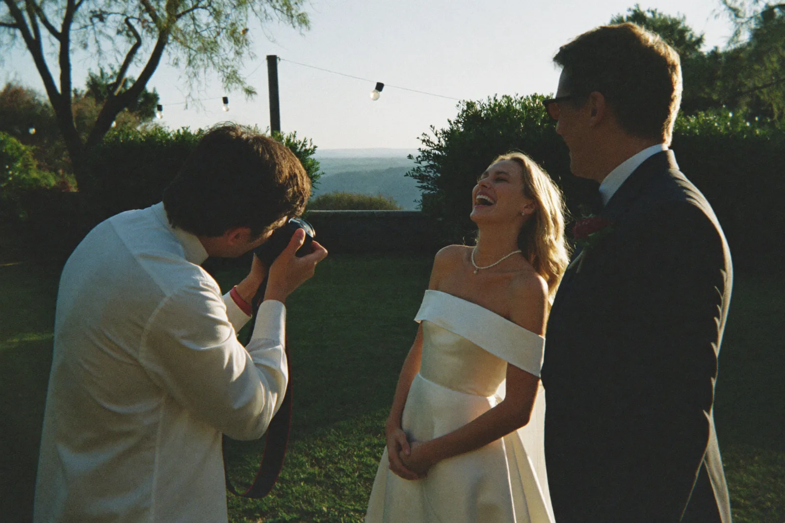 Wedding photographers capturing a couple outdoors