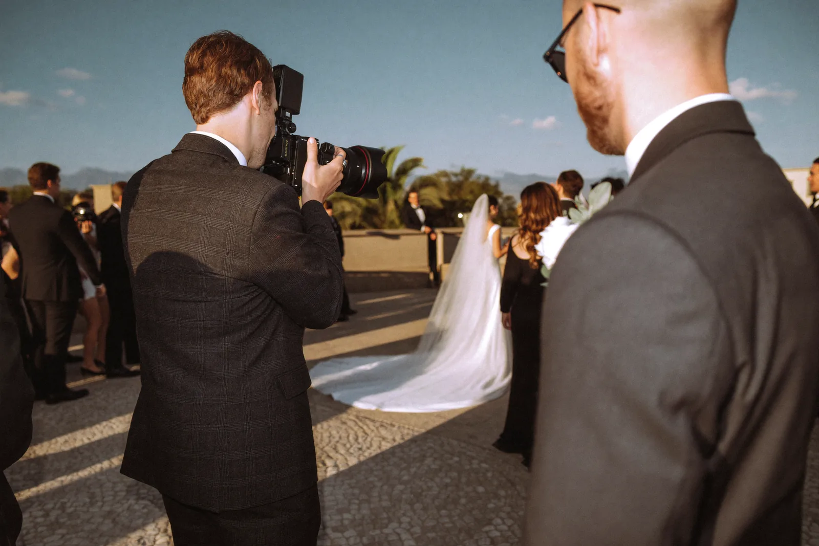 Photographer capturing a wedding moment on camera