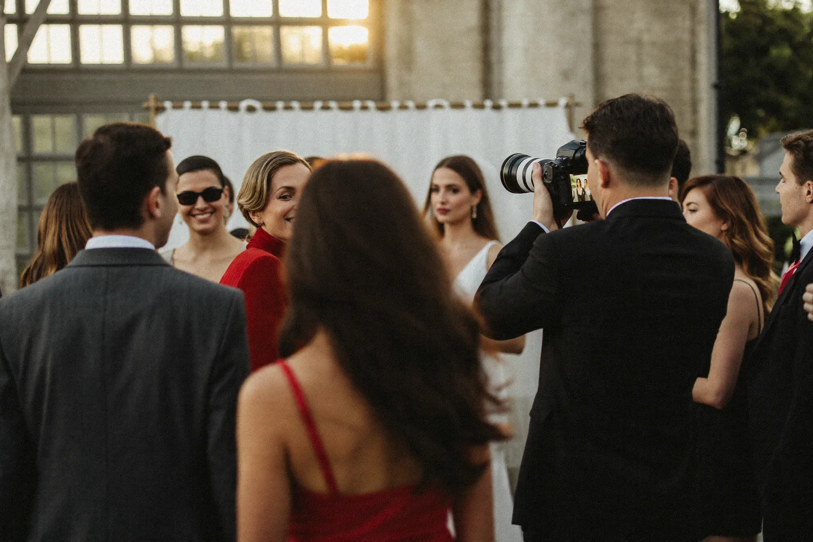 Photographer capturing an outdoor wedding ceremony