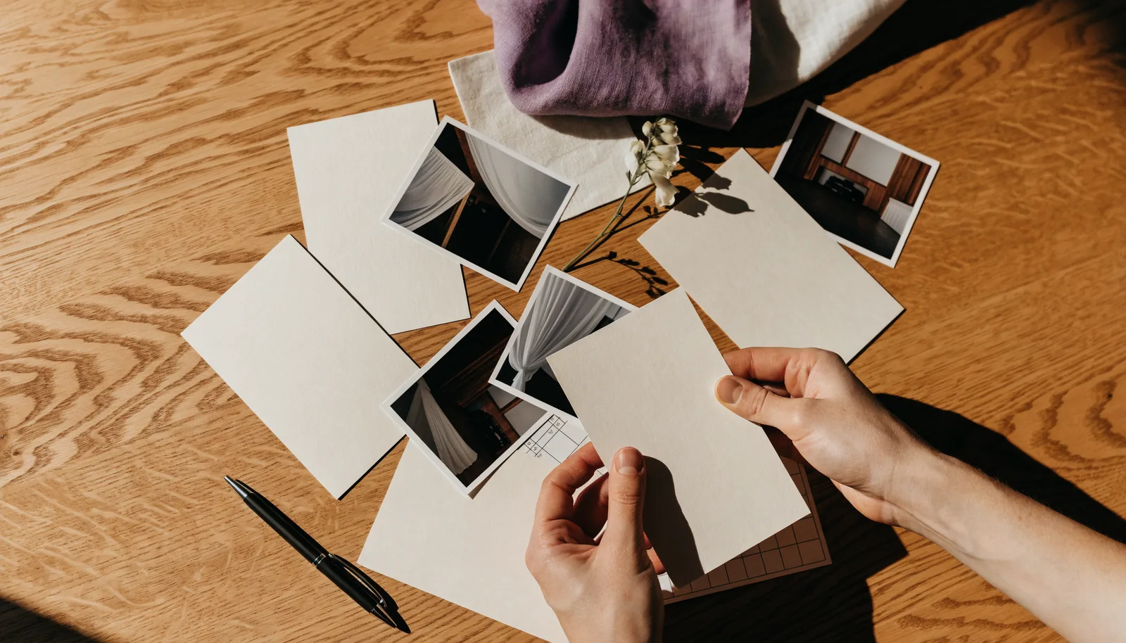 Wedding stationery, ribbons, place settings, and planning notes arranged on a table